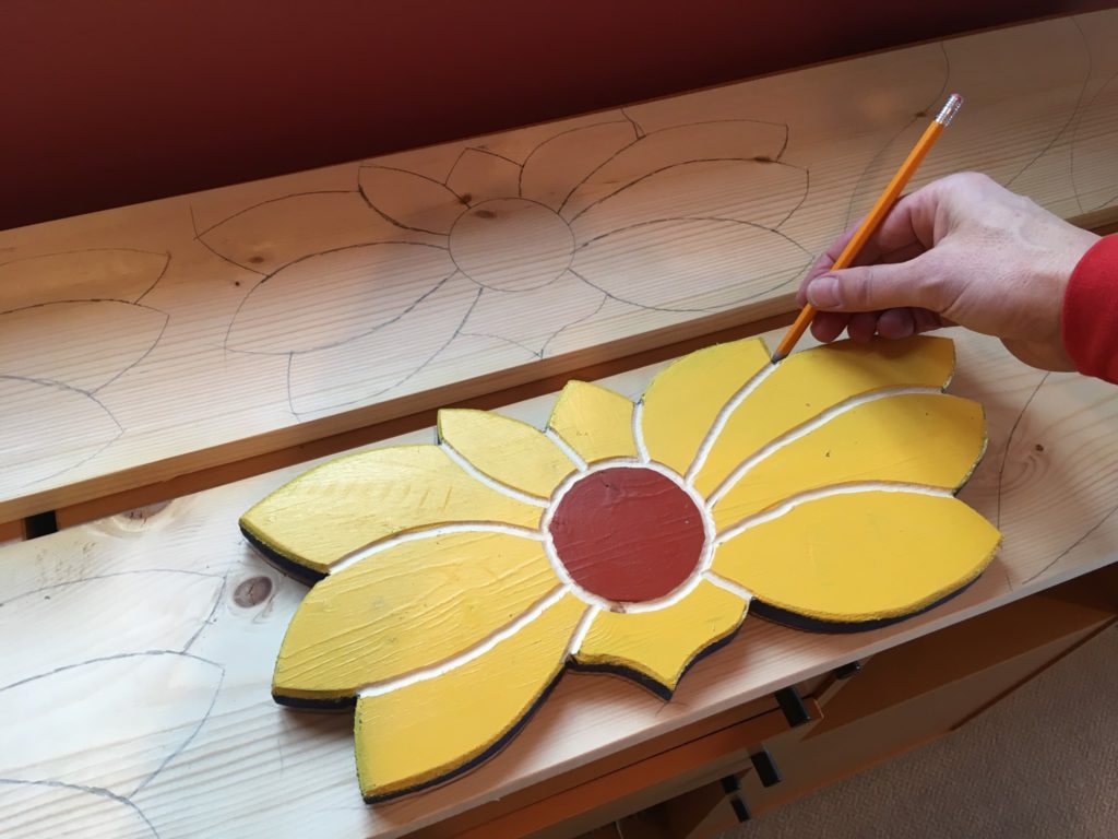 Tracing flower shape on wooden board