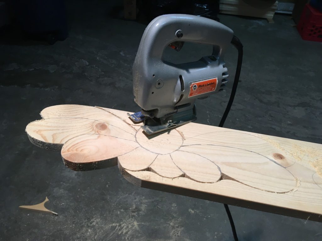 Using a jig saw to cut out each flower